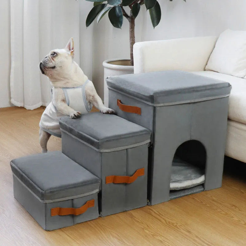 Foldable gray cloth pet storage stairs with two or three steps, placed next to a bed for dog access