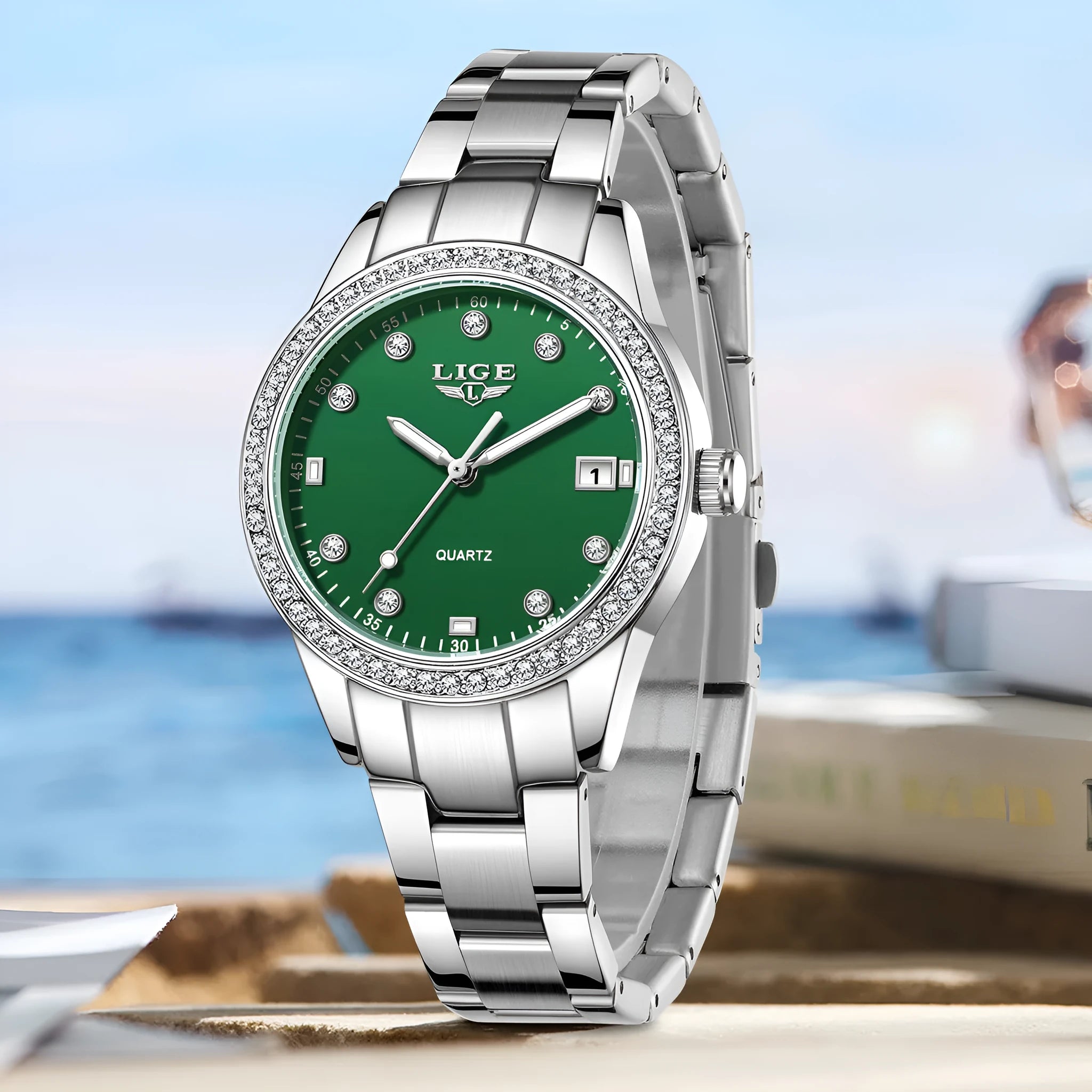 Silver stainless steel women's watch with diamond-encrusted bezel and luminous hands on a 34mm round dial.