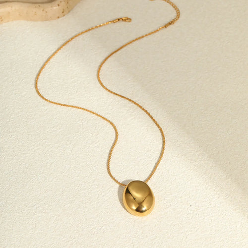Gold geometric pendant necklace on a stainless steel chain with adjustable length.