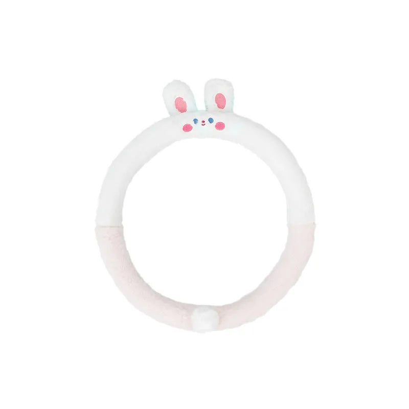 Plush rabbit fur style steering wheel cover with embroidered panda design, fitted on a car wheel