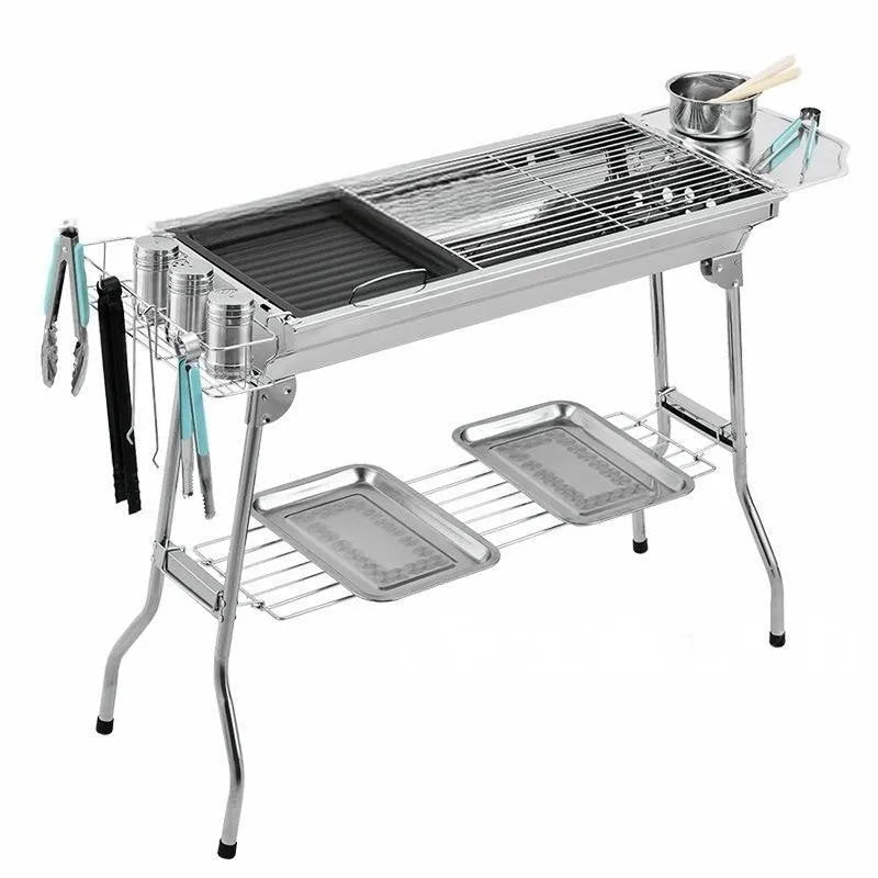 Stainless steel portable folding barbecue grill with cooking grate, shown in a natural steel colour.