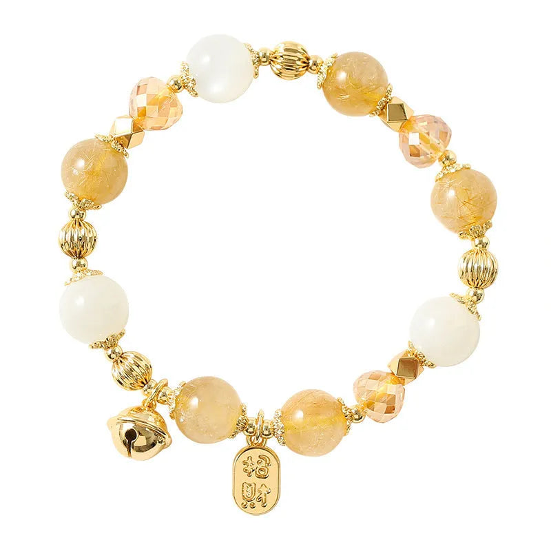 Gold rutilated quartz crystal bracelet with a ringing bell charm in Korean style.