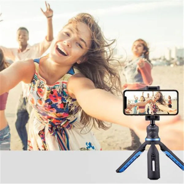 Black plastic and aluminium desktop tripod stand holding a mobile phone.