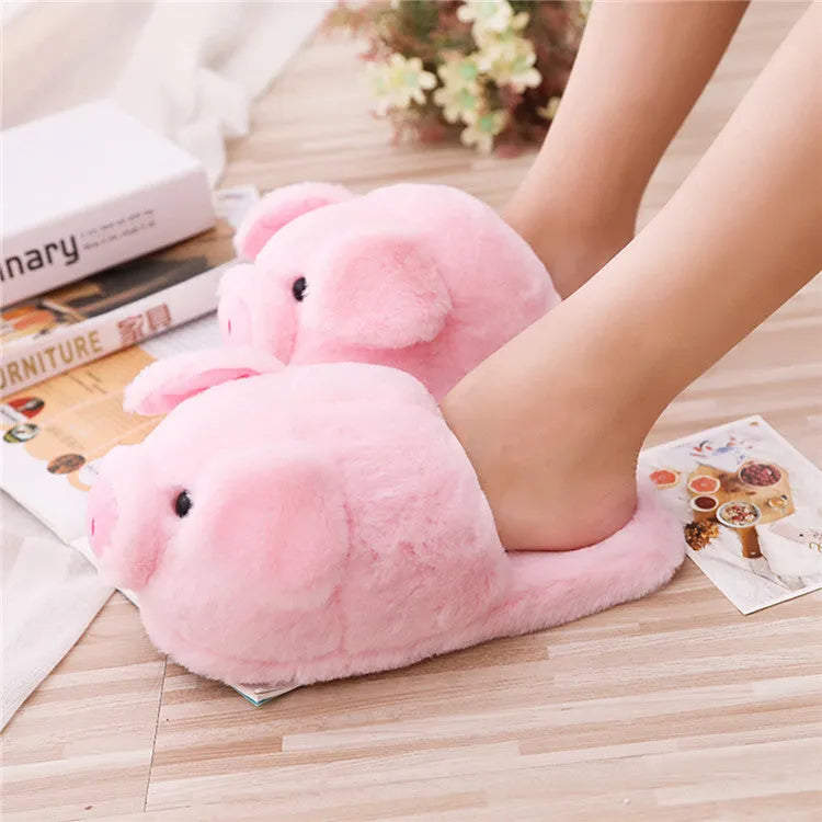 Pink adult pig-shaped floor slippers with short plush fabric on a white background.