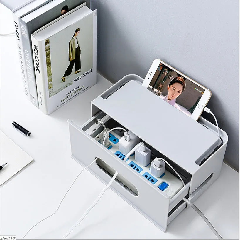 Grey and white plastic wireless router storage box with cable management holes and storage compartments