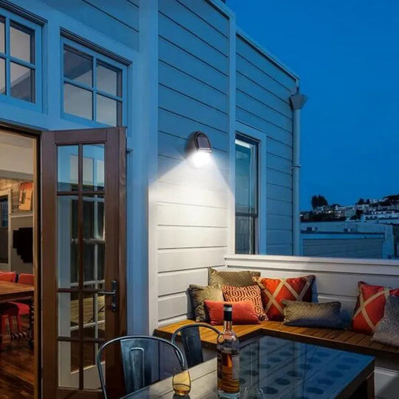 Black solar-powered LED wall light with automatic light sensor for outdoor use