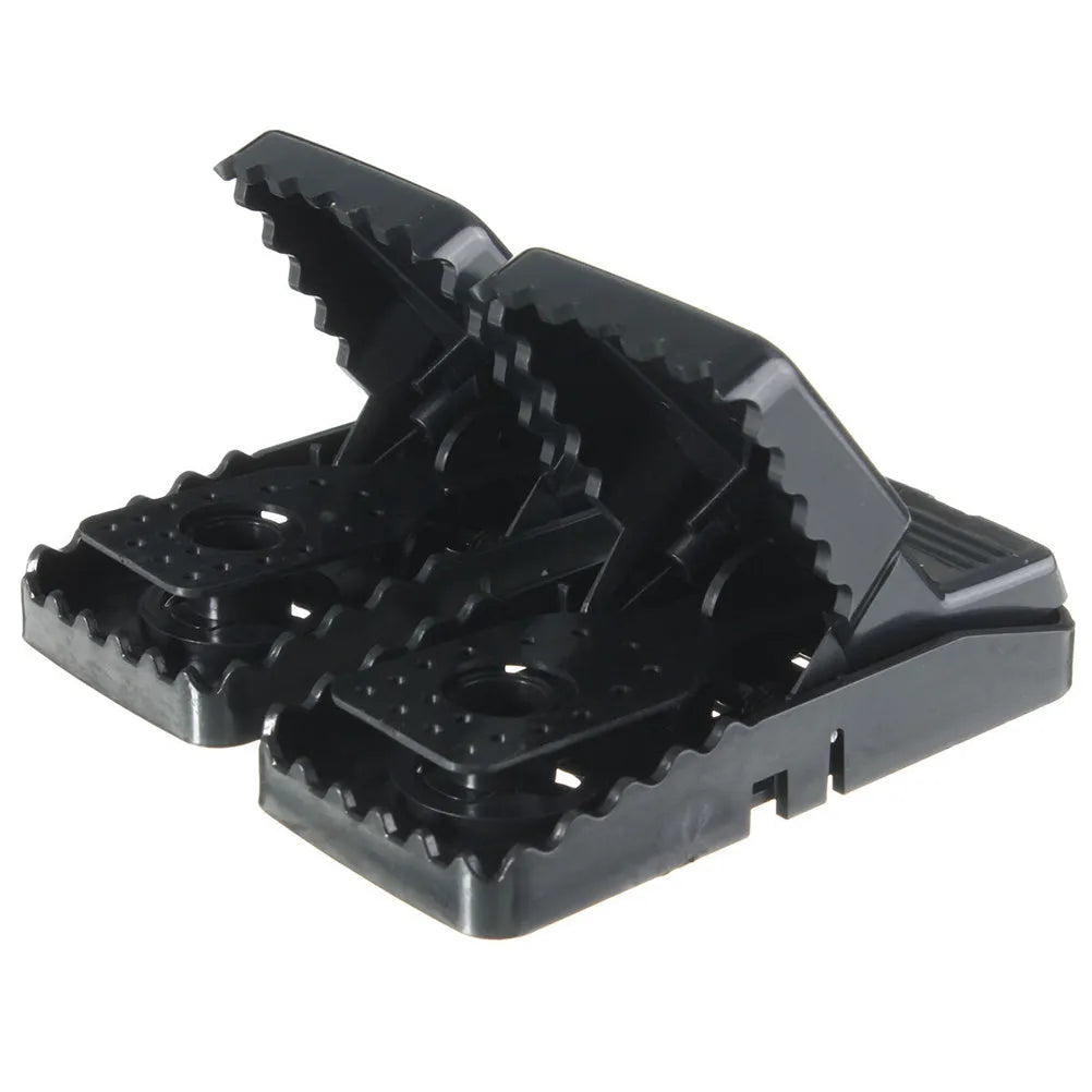Six black plastic snapping mousetraps showing compact size and smooth surface