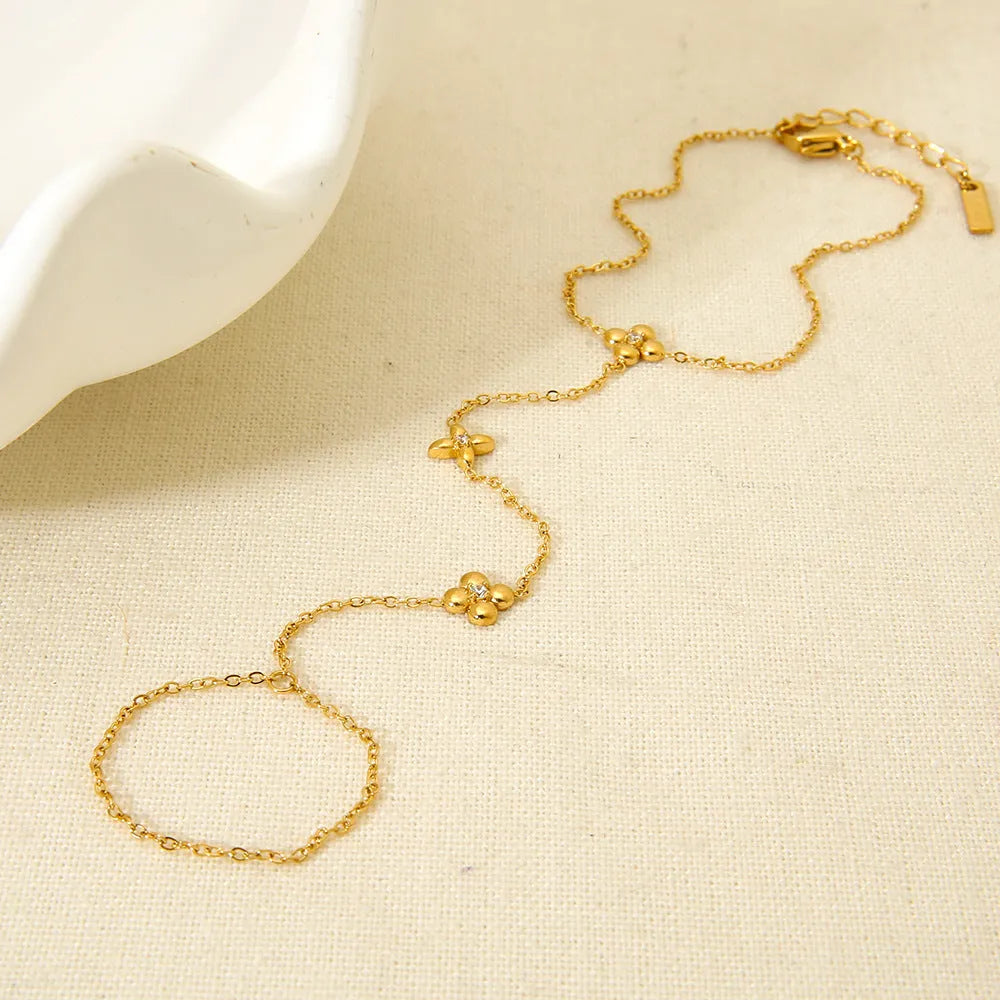 Gold geometric women's bracelet with floral and eight-pointed star design on stainless steel