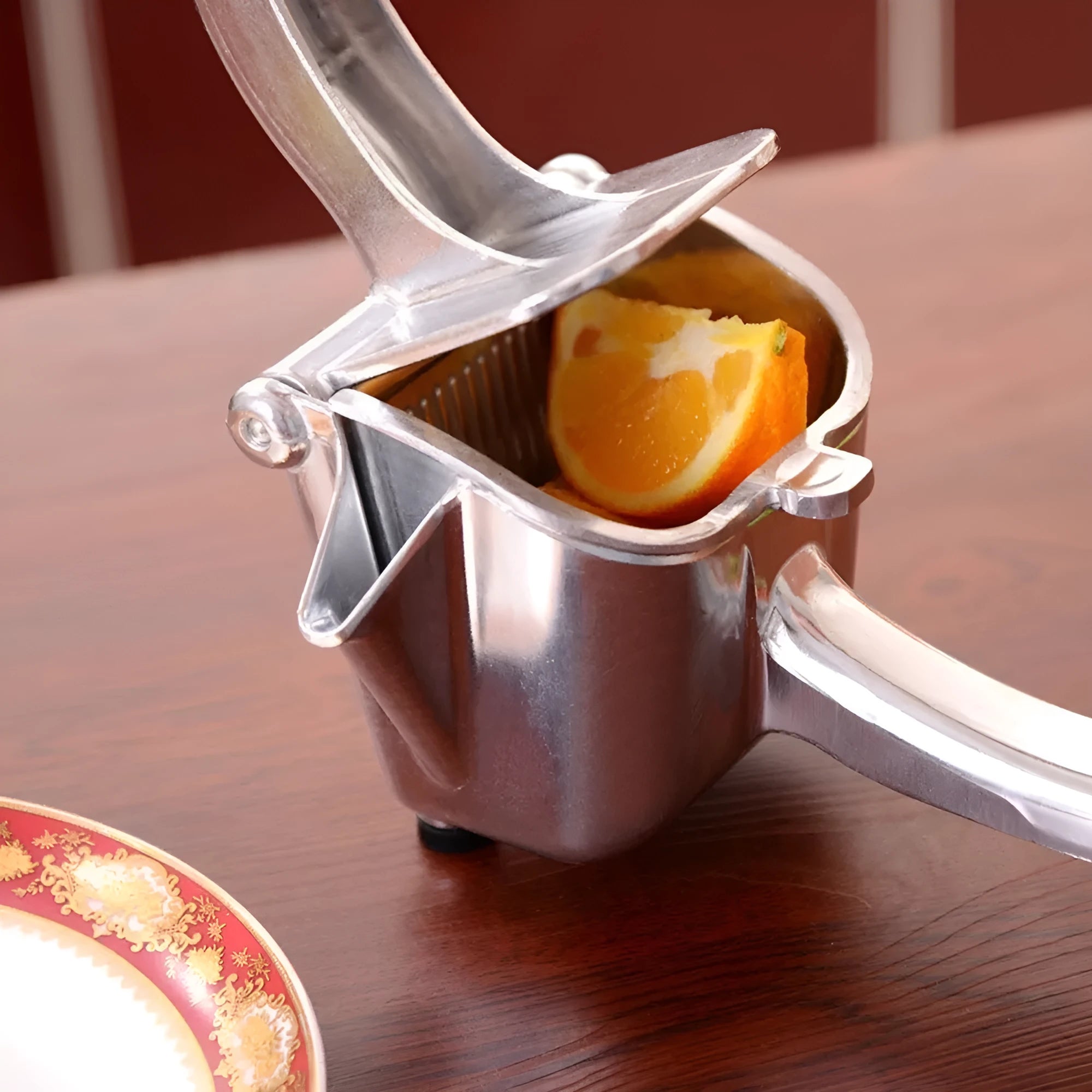 Silver heavy duty lemon squeezer with large bowl on a kitchen counter