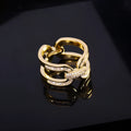 Gold electroplated copper round scarf ring with geometric shape on a silk scarf