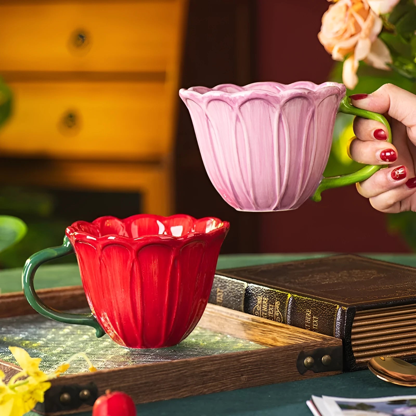 A red and purple floral ceramic cup with a 500ml capacity on a wooden table.