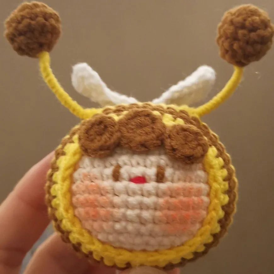 Handmade crocheted bee colony wool doll with bee pendant accessory in plush soft toy construction