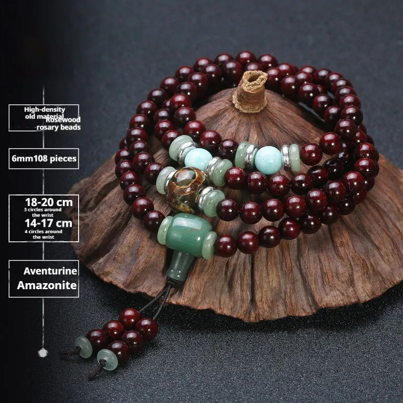 Men's rosewood 108 bead mala bracelet with decorative lapis lazuli beads on wrist.