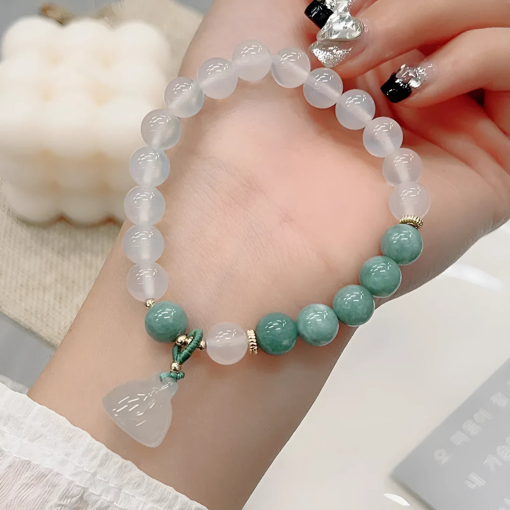 Close-up of a women's retro Chinese style agate bracelet with a carved lotus seedpod design.