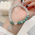 Close-up of a women's retro Chinese style agate bracelet with a carved lotus seedpod design.