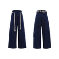 Men's dark blue straight-leg jeans showing loose fit, belt stitching with tassel, and zip pocket decorations.