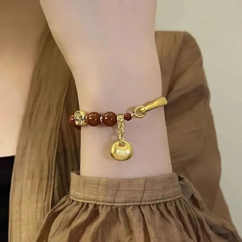 Golden south red agate character ingot bracelet handmade from glass and coloured glaze