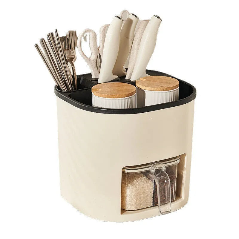 White rotating kitchen storage bucket with four-compartment spice box lid next to cutlery.