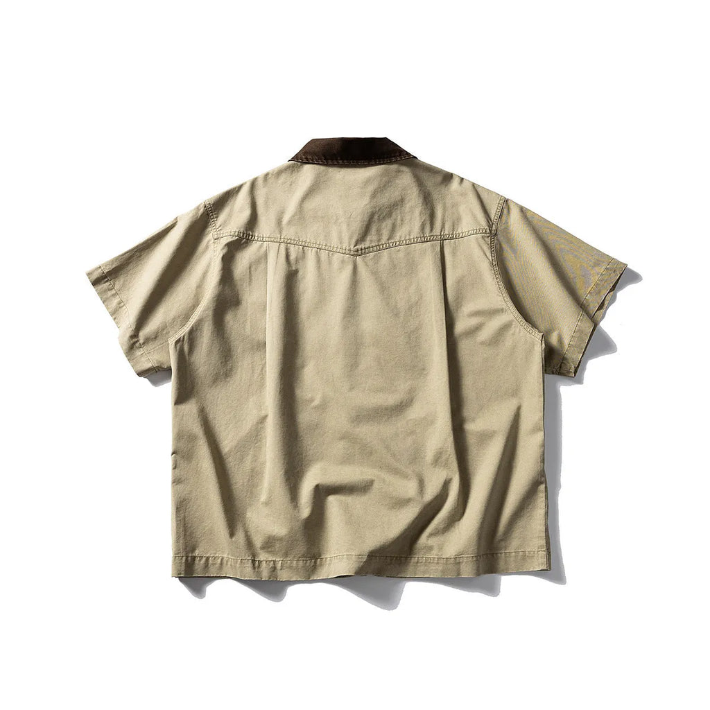 Grey washed cotton short sleeve overall shirt on a hanger, loose fit.