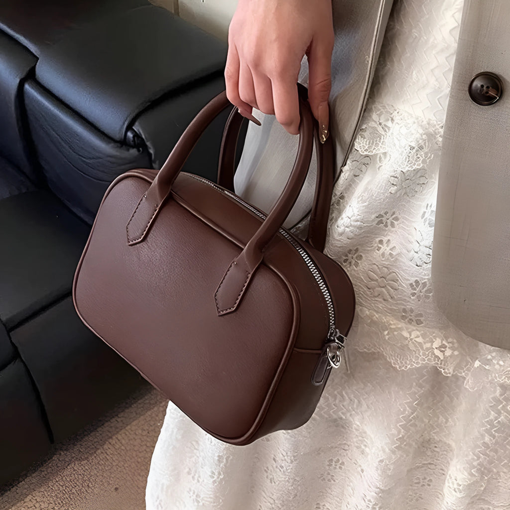 Retro small square PU leather messenger bag in black and coffee brown colours with a single adjustable strap.