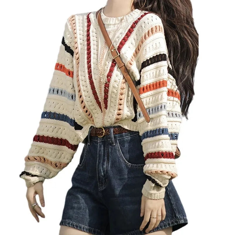 Retro rainbow striped loose fit sweater with batwing sleeves on a hanger.