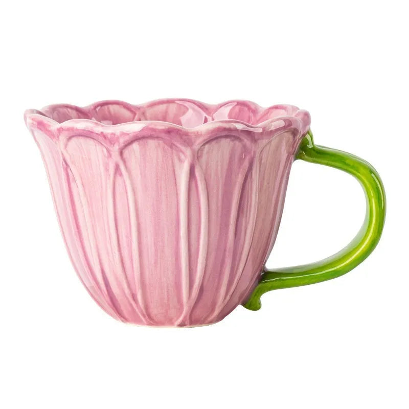 A red and purple floral ceramic cup with a 500ml capacity on a wooden table.