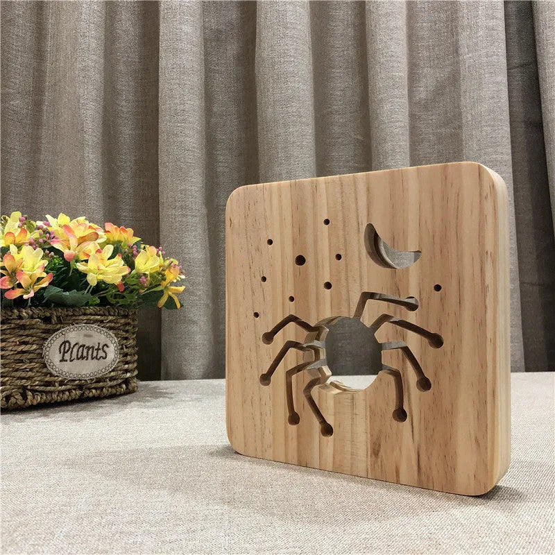Halloween spider creative light made from pine wood with warm white glow on a wooden table