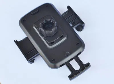 Black universal car phone holder installed in a CD port with adjustable arms for mobile phone or GPS navigation