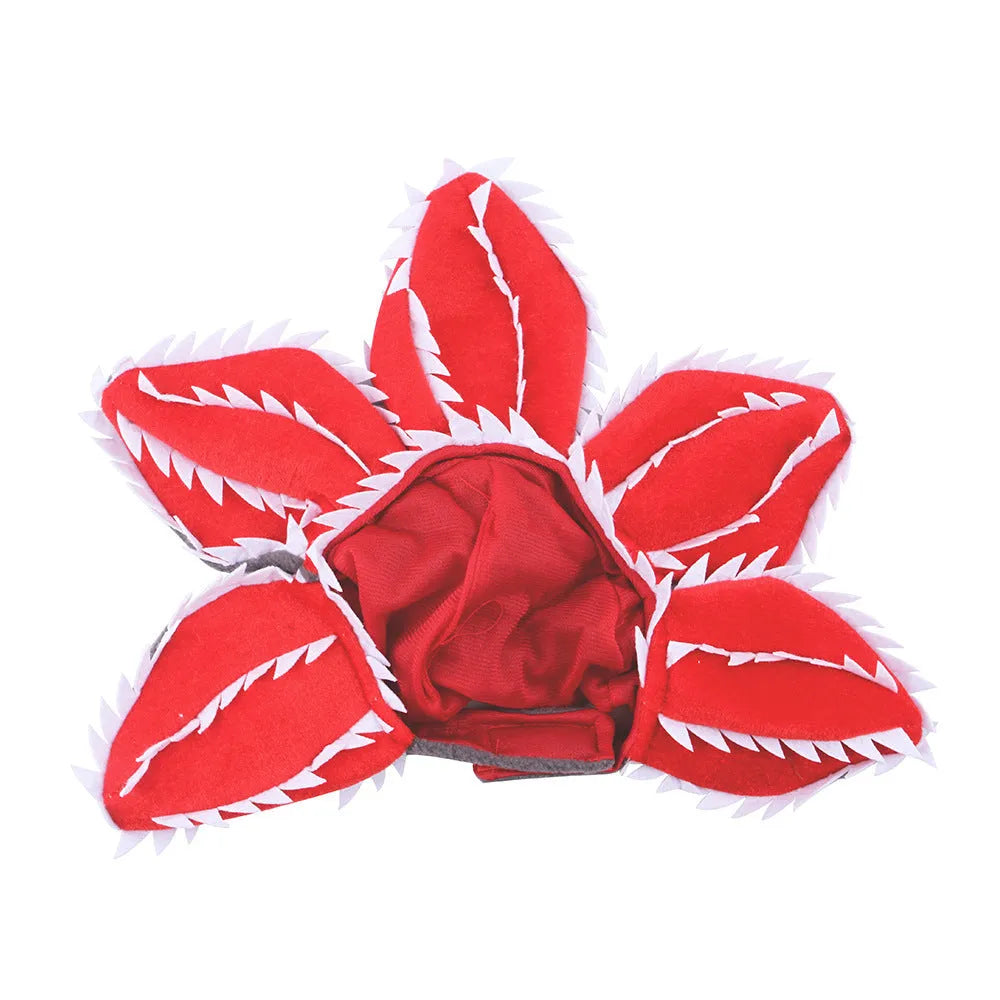 Dog wearing Halloween demon headband costume with chomper teeth and pink flower decoration