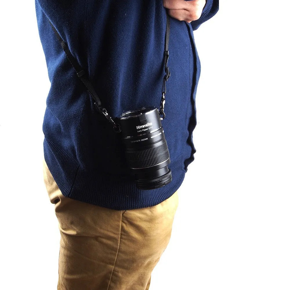 Aluminium camera lens flipper holder with two lenses attached on a cotton shoulder strap.