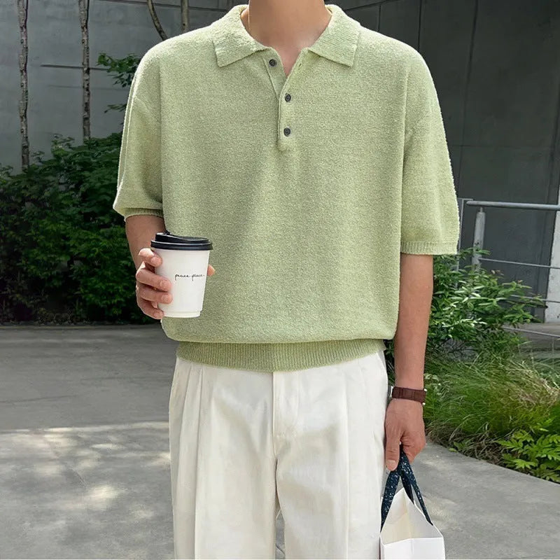 Man modelling a caramel-coloured retro asymmetric knitted polo shirt with short sleeves.