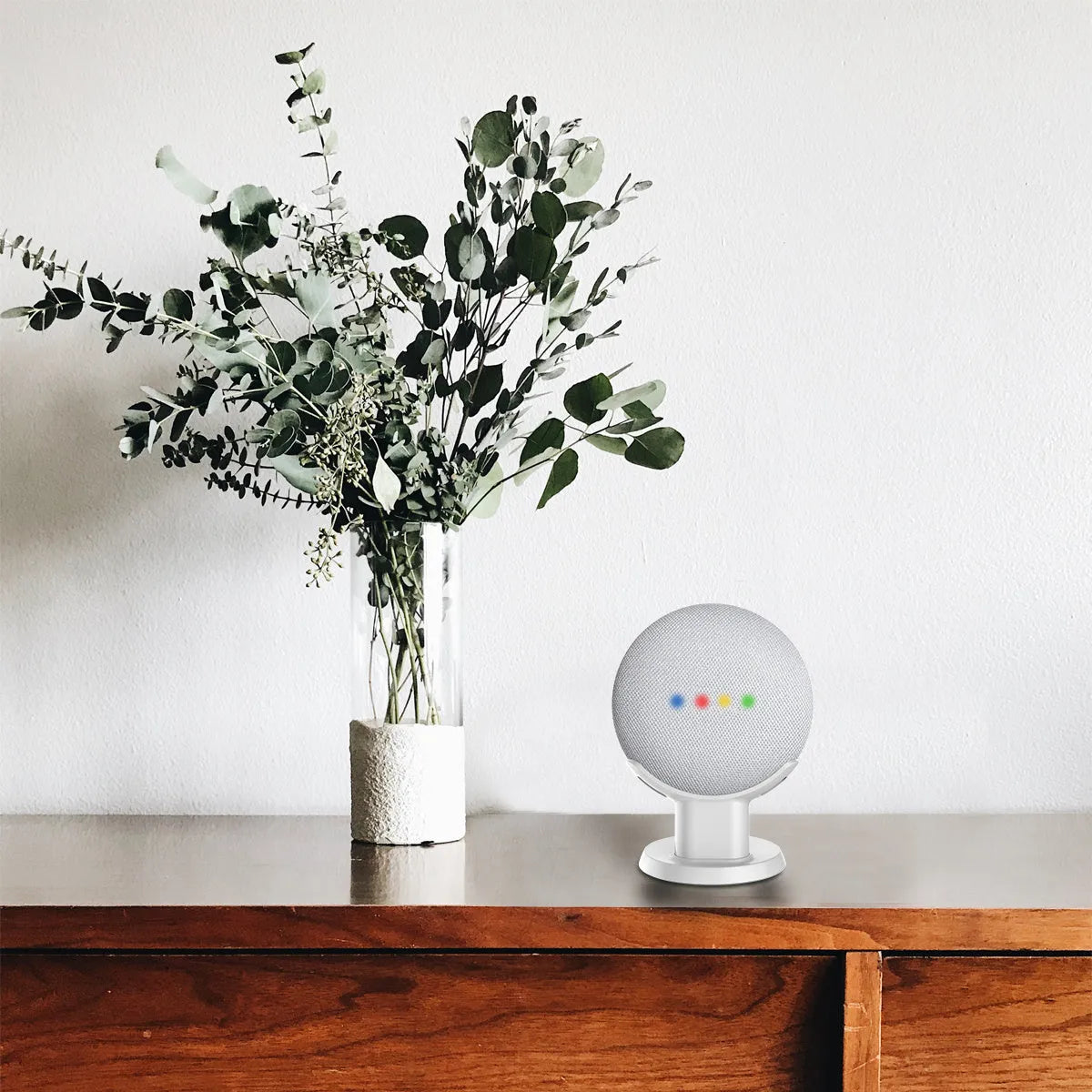 Black PlusAcc Google Home Mini stand holder on a wooden desk.