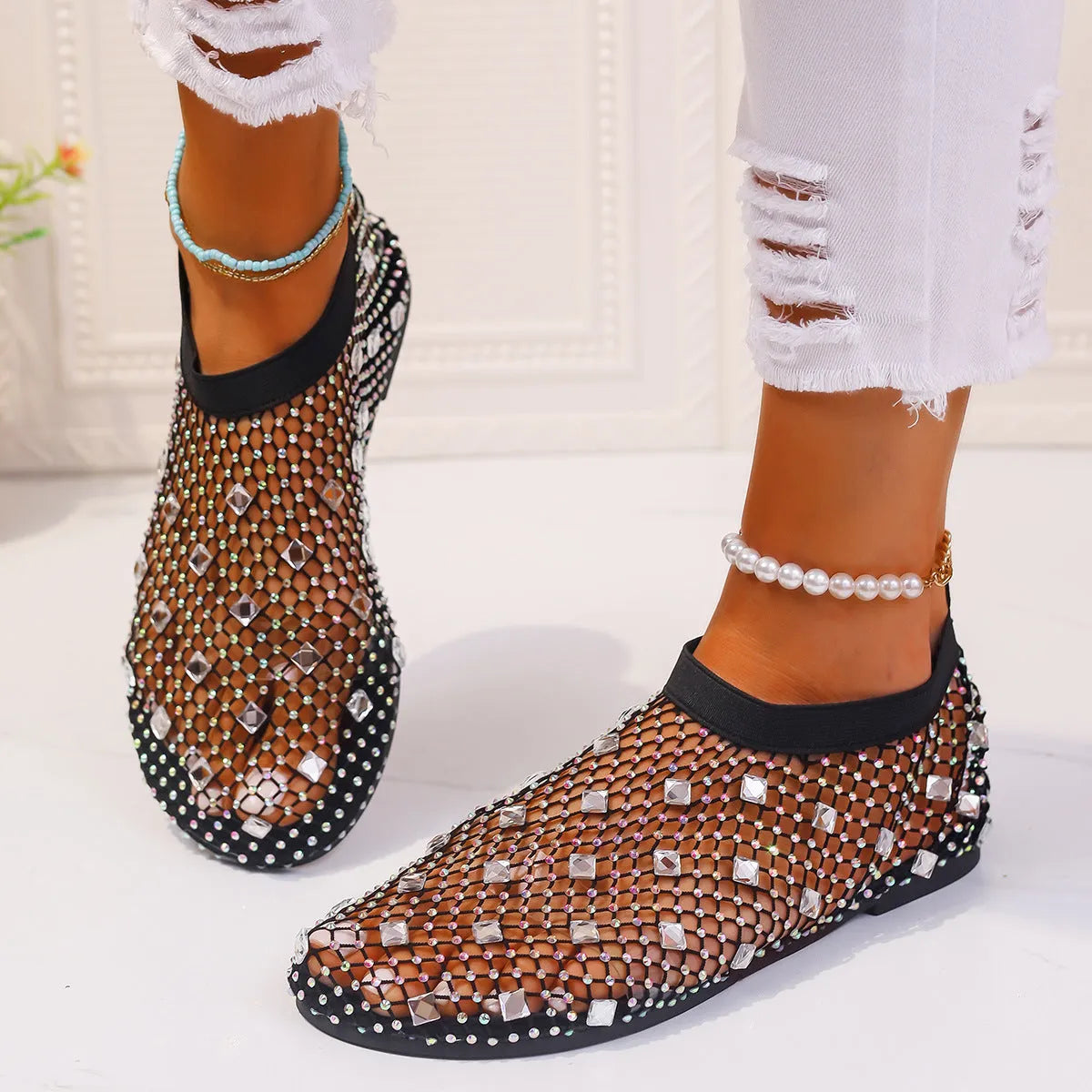 Women's colourful rhinestone flat sandals with mesh upper and rubber sole.