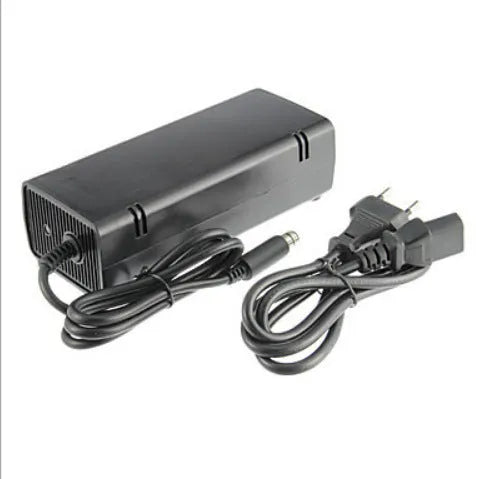 Black Xbox 360 E console AC power adapter with plug options for EU, UK, and US sockets.