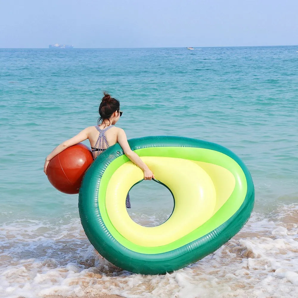 Green avocado-shaped inflatable pool float measuring 169cm long on blue water