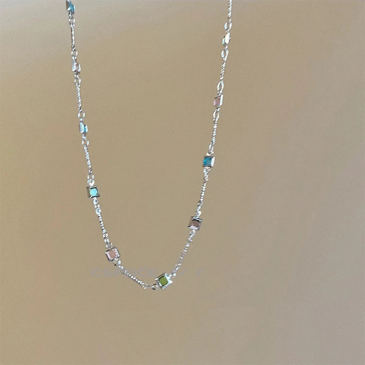Square colour geometric alloy clavicle chain necklace with artificial crystal detail in gold tone.