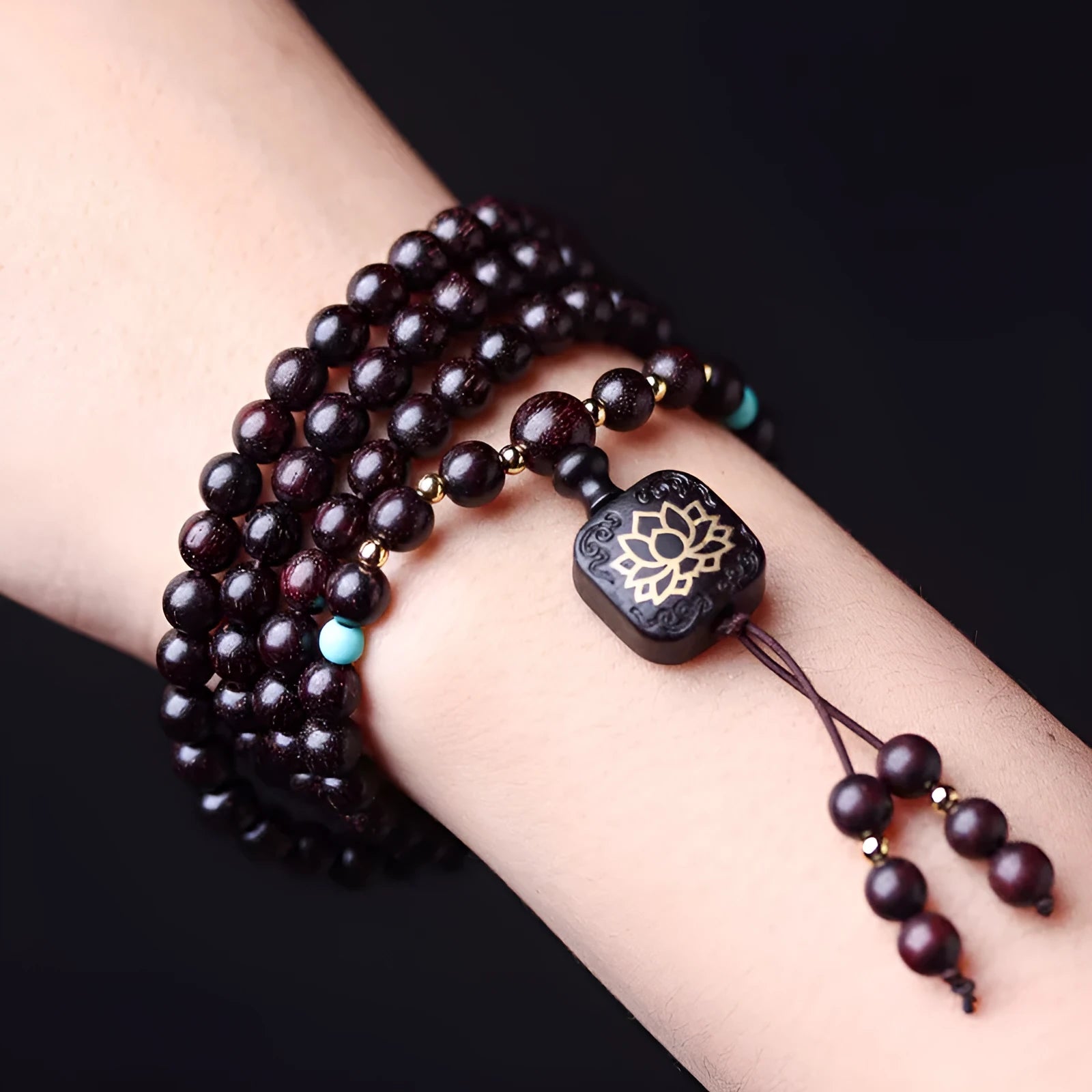 Zambia rosewood Buddha beads bracelet with 0.6 cm beads and flat lotus pendant on wooden surface