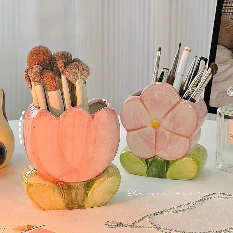 Ceramic floral pen holder box in pink tulip design on a desk.