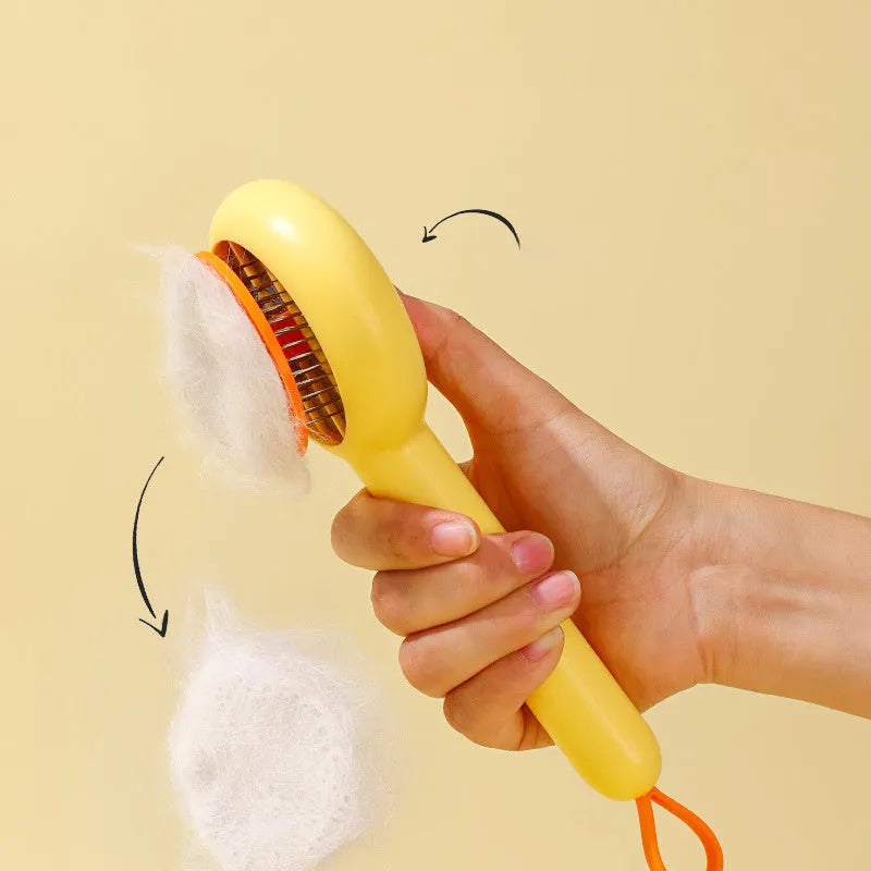 Small yellow duck-shaped pet grooming comb with needle tines for hair removal from cats and dogs.