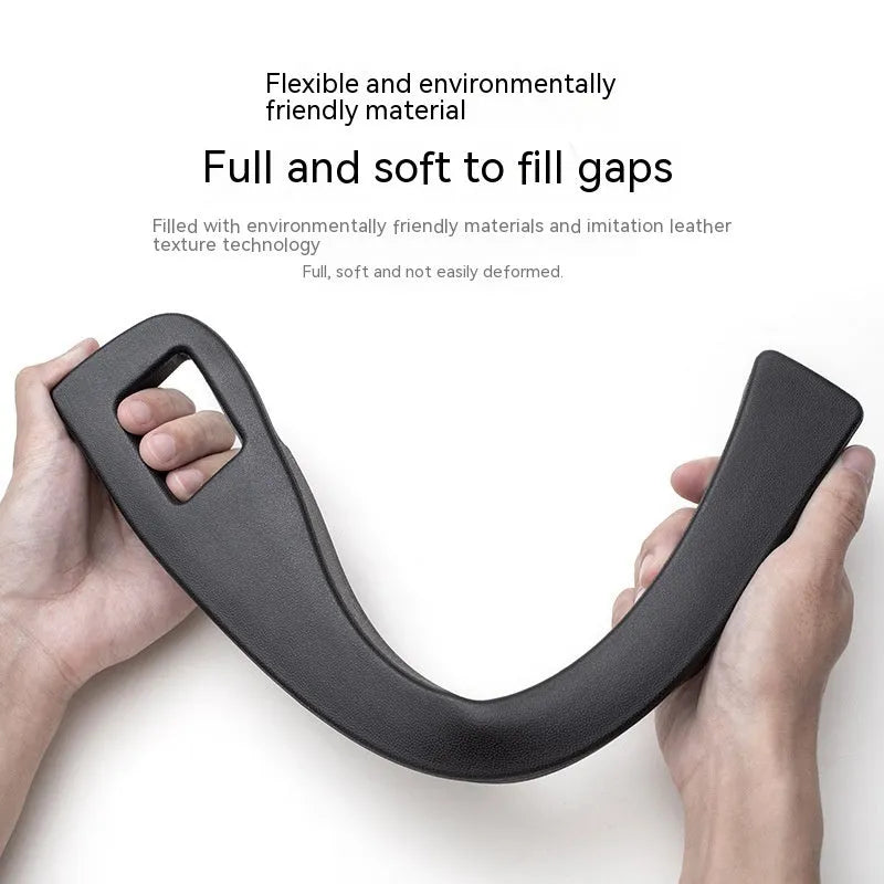 Black plastic car seat gap storage organiser box with handle inserted between vehicle seats