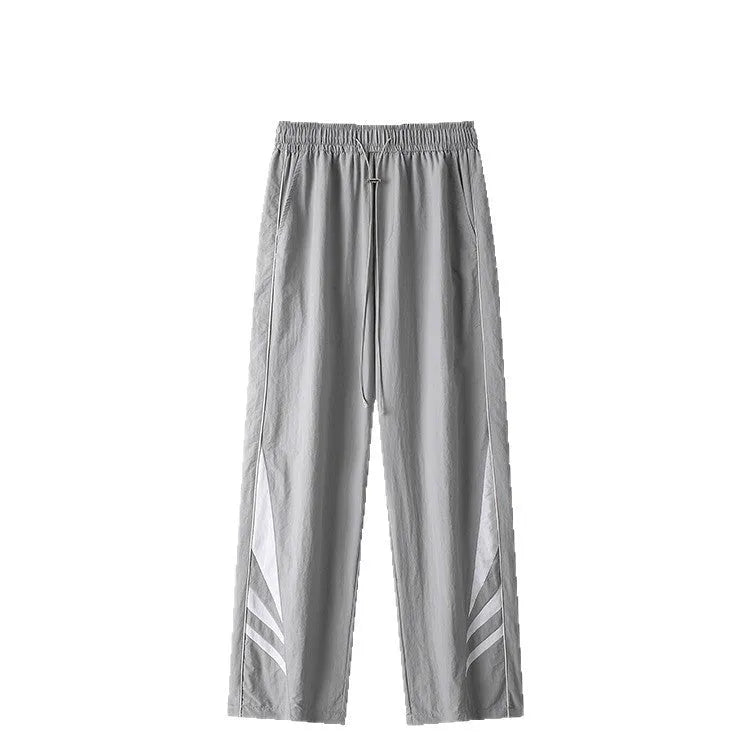 Plus-size men's straight-leg casual sports trousers in grey, showing loose fit and elastic waist.