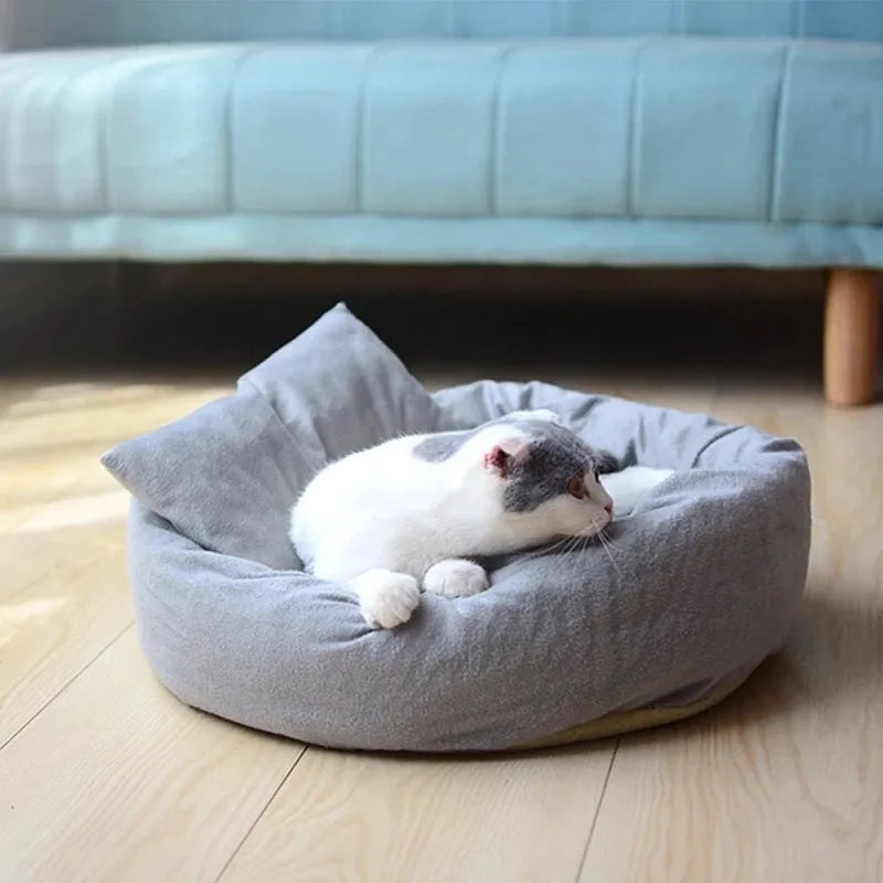 Grey round plush pet bed with removable pillow and non-slip base in four size options