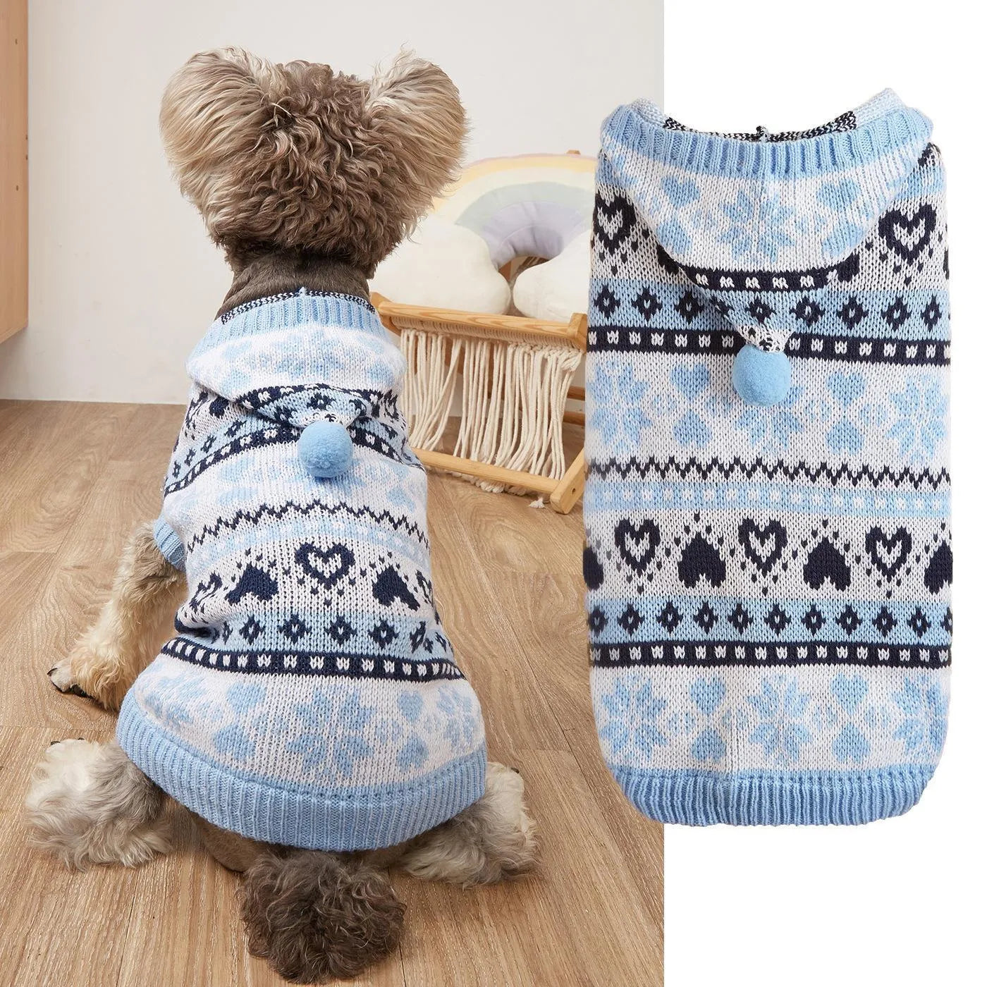 Blue knitted dog sweater with white snowflake and love heart patterns on a striped camouflage background.