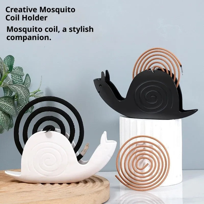 Black plastic universal mosquito incense holder on a table, simple portable design with creative animal style