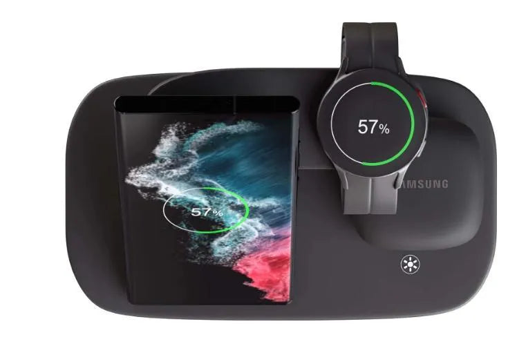White vertical 3-in-1 wireless charging stand holding a mobile phone, a smartwatch, and wireless earbuds.