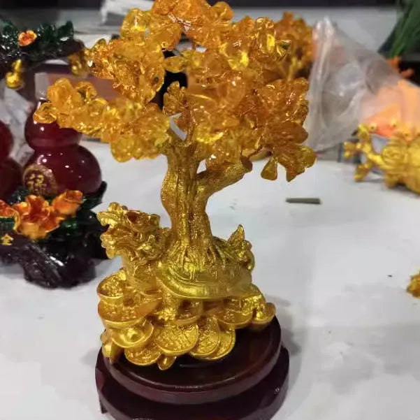 Citrine-coloured resin money tree Feng Shui ornament with a small water turtle design.