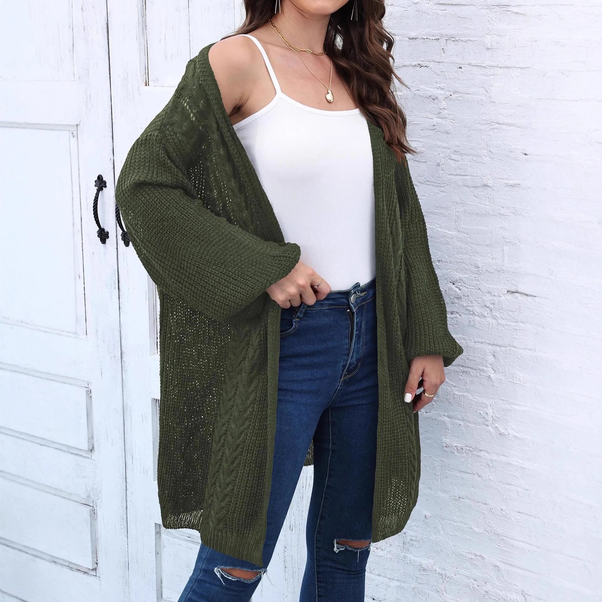Women's longline loose acrylic sweater coat in army green colour, shown on a model.