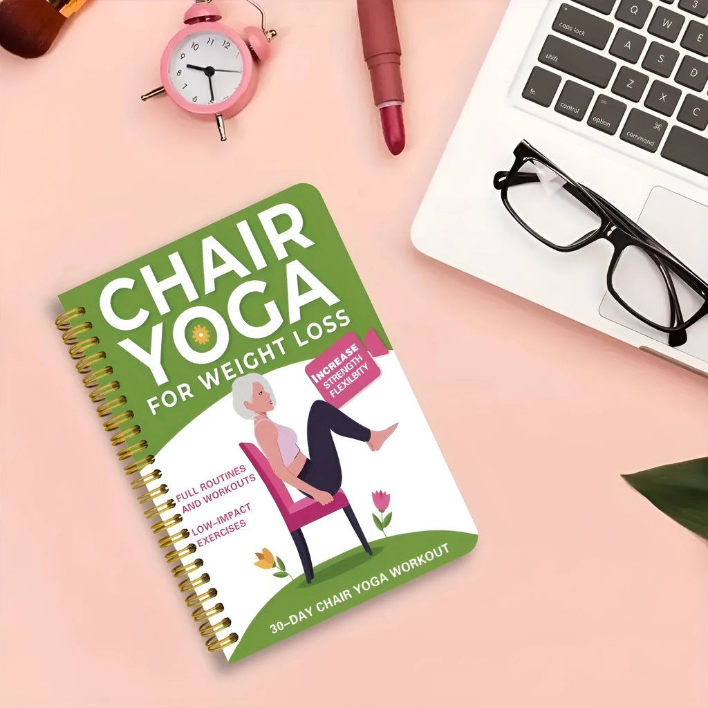 Green coil-bound 30-day chair yoga training notebook with open pages showing exercise plans