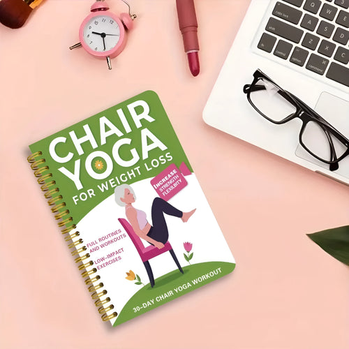 Green coil-bound 30-day chair yoga training notebook with open pages showing exercise plans