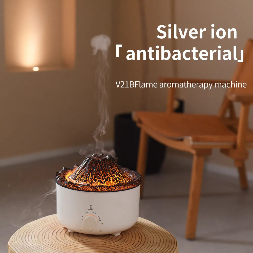 White simulated flame volcano humidifier and aroma diffuser with remote control on wooden surface